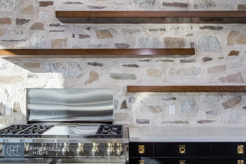 Floating walnut shelves in an industrial farmhouse kitchen