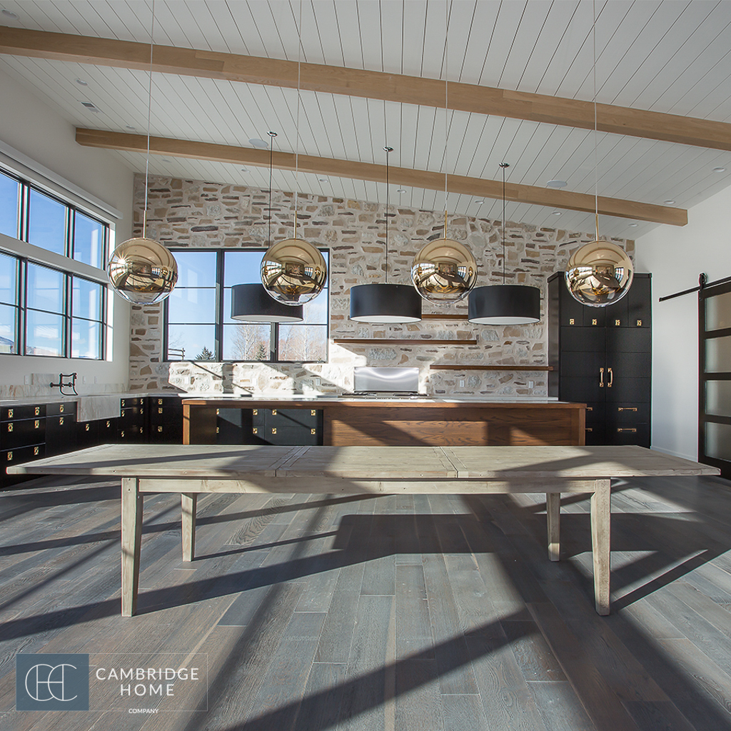 black cabinets and walnut table in industrial farmhouse kitchen